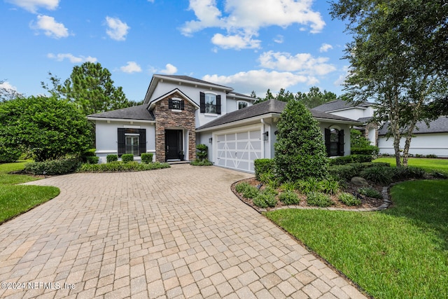 view of front of home featuring a front yard and a garage