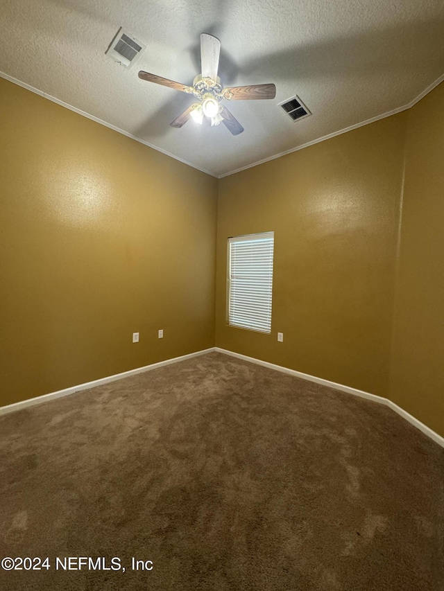 carpeted spare room with ceiling fan, ornamental molding, and a textured ceiling