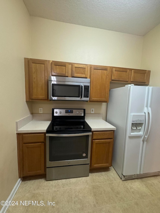 kitchen featuring stainless steel appliances and a textured ceiling