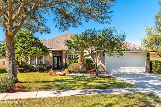 view of front of house with a garage and a front lawn