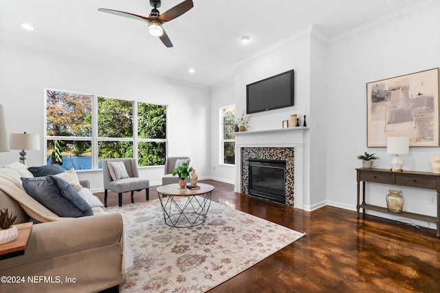 living room with ceiling fan, a fireplace, dark wood-type flooring, and ornamental molding