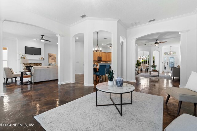 living room featuring ceiling fan with notable chandelier, crown molding, and french doors