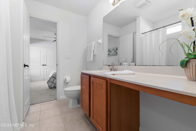 bathroom featuring ceiling fan, tile patterned flooring, vanity, and toilet