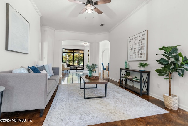 living room with dark hardwood / wood-style floors, ceiling fan, and crown molding