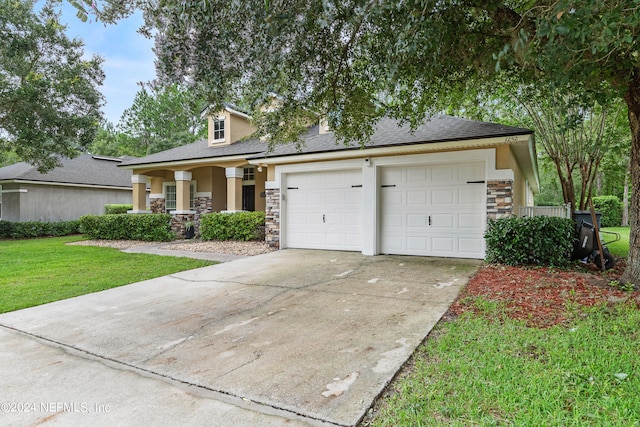 view of front of home with a garage and a front lawn