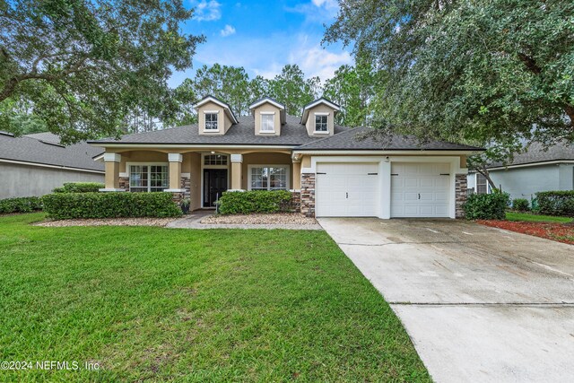 view of front facade featuring a garage and a front lawn