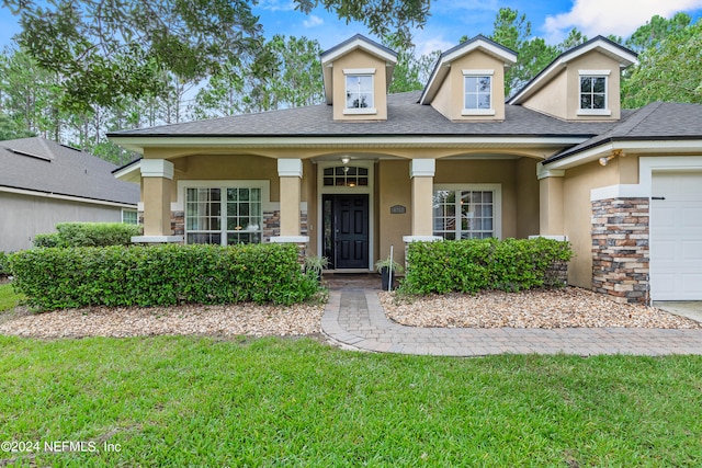 view of front of home featuring a garage and a front lawn