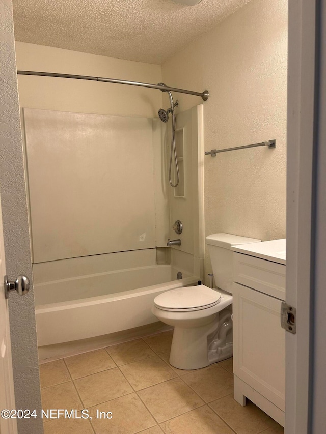 full bathroom featuring a textured ceiling, tile patterned floors, shower / bathing tub combination, vanity, and toilet