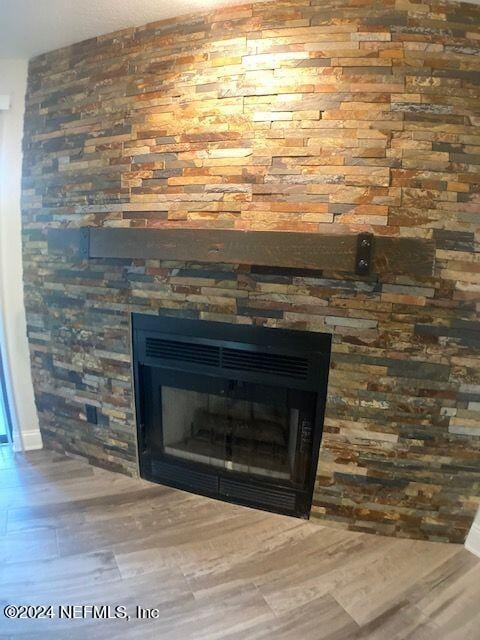 interior details with hardwood / wood-style floors and a fireplace