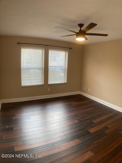 empty room featuring dark hardwood / wood-style flooring and ceiling fan