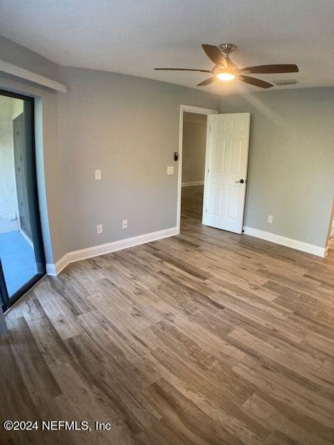 empty room with hardwood / wood-style flooring, a textured ceiling, and ceiling fan