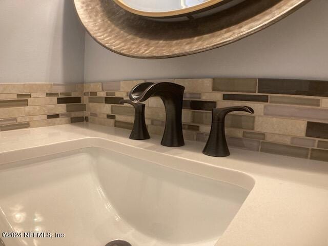 room details featuring tasteful backsplash and sink