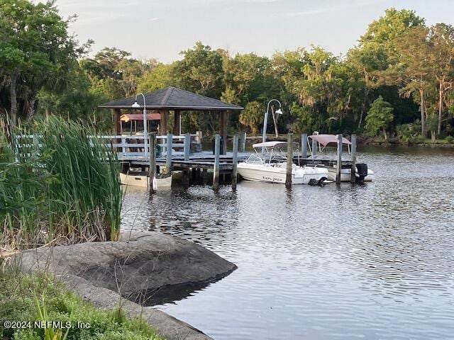 view of dock featuring a gazebo and a water view