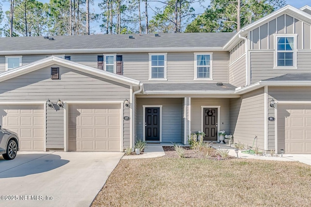 multi unit property featuring a garage and a front yard