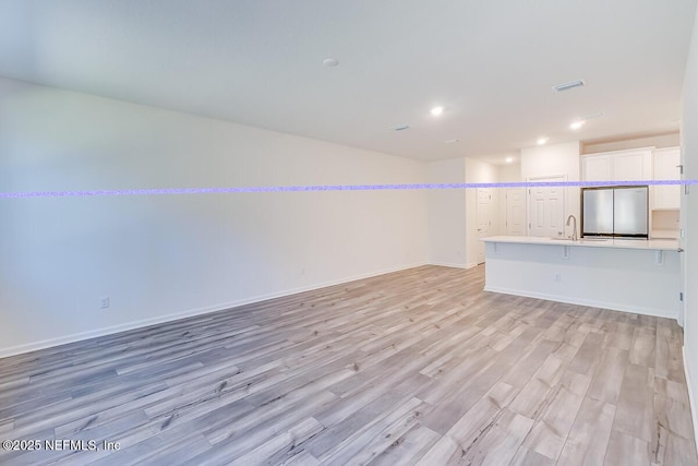 interior space with sink and light wood-type flooring