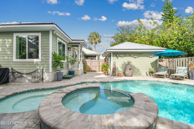 view of swimming pool featuring an in ground hot tub