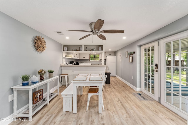 dining space featuring light wood-type flooring and ceiling fan