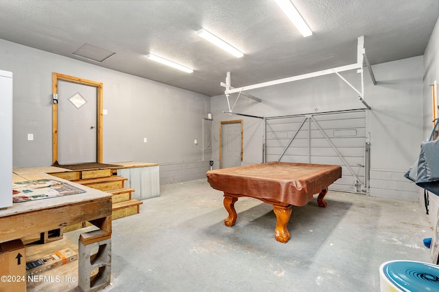 recreation room featuring concrete floors, billiards, and a textured ceiling