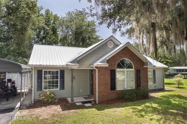 view of front of home with a front yard and a carport