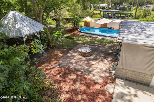 view of yard featuring a fire pit and a gazebo