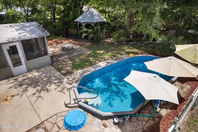 view of pool with an outbuilding and a patio area