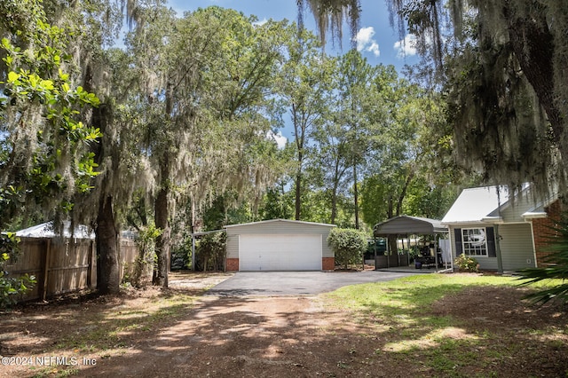 view of front facade featuring a garage, an outdoor structure, and a carport