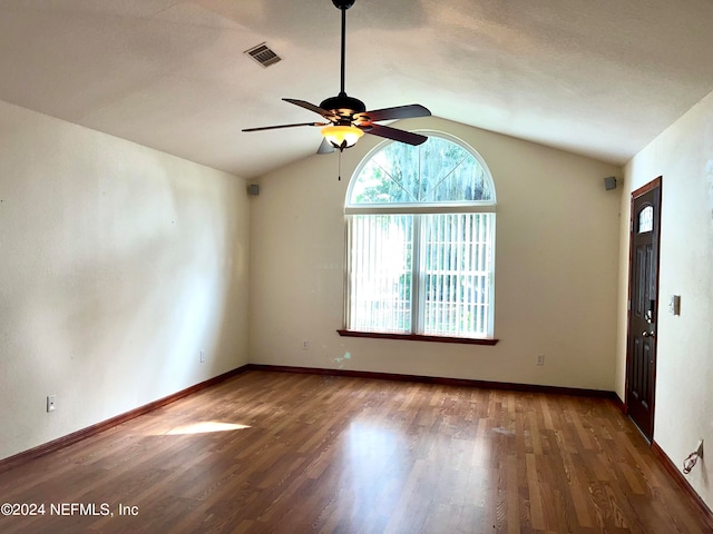 unfurnished room featuring ceiling fan, wood-type flooring, and lofted ceiling