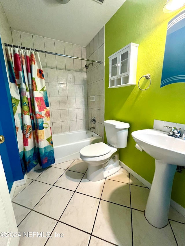 full bathroom with tile patterned floors, toilet, sink, and shower / tub combo with curtain