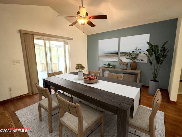 dining area with dark wood-type flooring, ceiling fan, and lofted ceiling