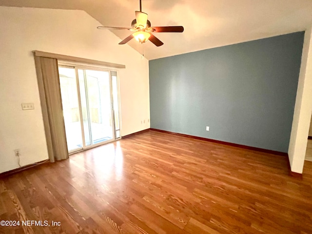 empty room featuring ceiling fan, wood-type flooring, and lofted ceiling