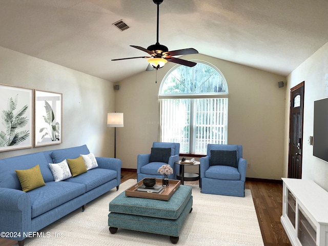 living room featuring ceiling fan, wood-type flooring, and lofted ceiling