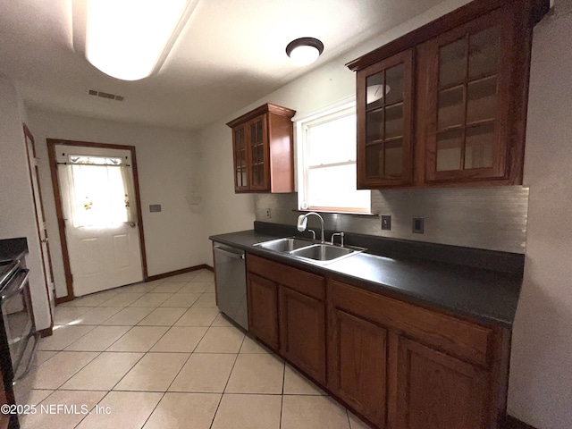 kitchen with light tile patterned flooring, sink, stainless steel dishwasher, and range