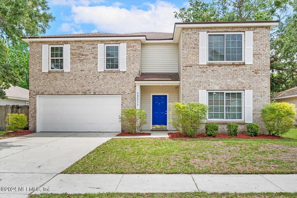 view of front of property featuring a garage and a front yard