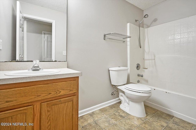 full bathroom with washtub / shower combination, vanity, toilet, and a textured ceiling