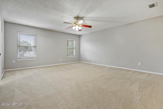 unfurnished room featuring plenty of natural light and light colored carpet