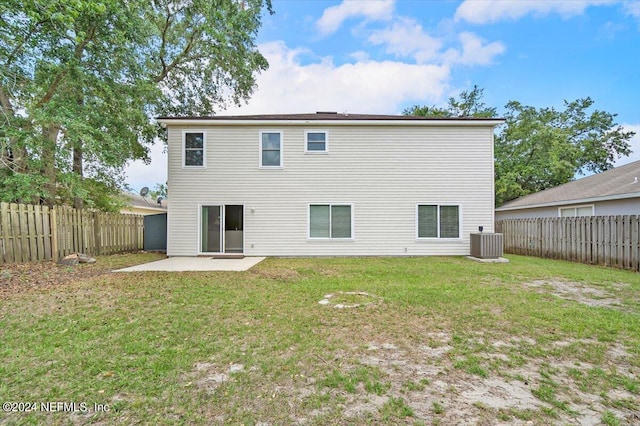 back of house featuring a patio, a yard, and central air condition unit