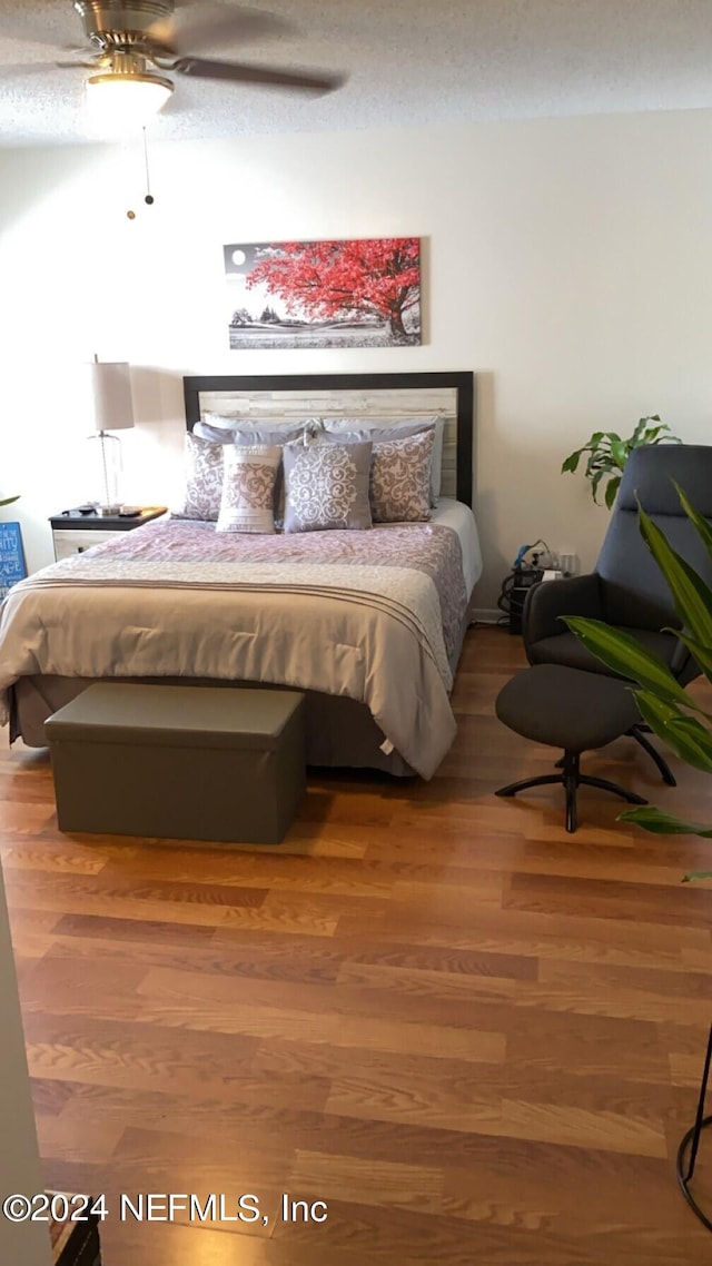 bedroom featuring wood-type flooring and ceiling fan