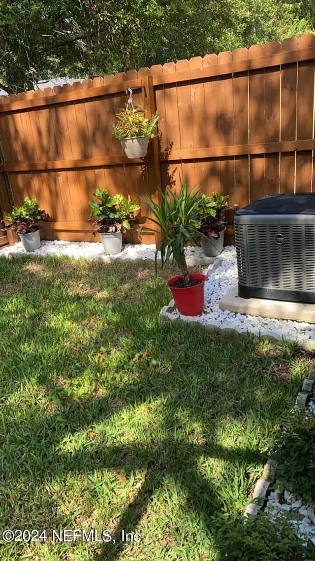 view of yard featuring central air condition unit