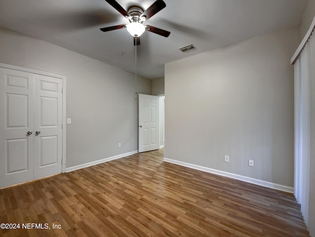 unfurnished bedroom featuring wood-type flooring and ceiling fan