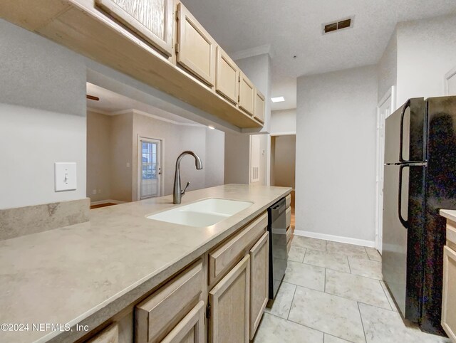 kitchen featuring dishwashing machine, light brown cabinets, ornamental molding, sink, and refrigerator