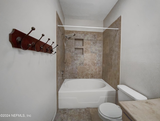 full bathroom with vanity, tiled shower / bath combo, toilet, and tile patterned floors