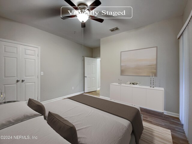 bedroom with ceiling fan, hardwood / wood-style flooring, and a closet