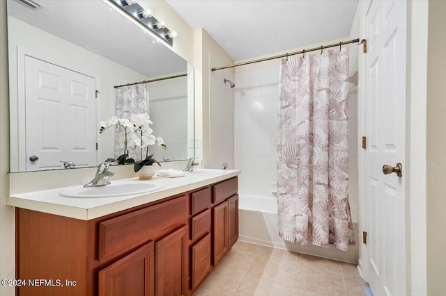 bathroom with vanity, tile patterned floors, a textured ceiling, and shower / bath combo with shower curtain