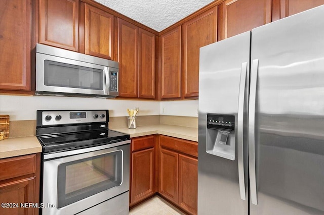 kitchen with light tile patterned flooring and stainless steel appliances