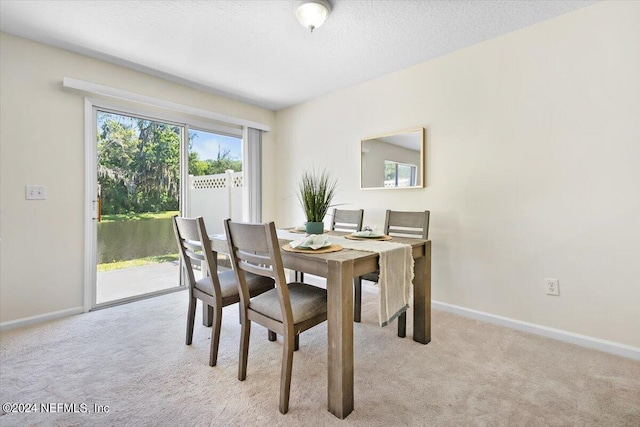 dining area featuring light colored carpet