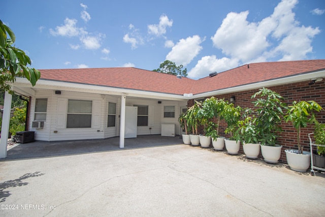 rear view of property with cooling unit