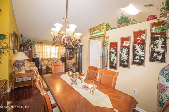 dining area with an inviting chandelier and hardwood / wood-style floors