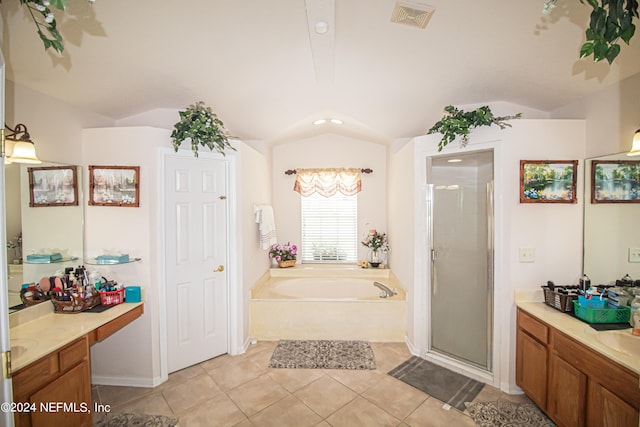 bathroom with lofted ceiling, tile patterned floors, separate shower and tub, and vanity