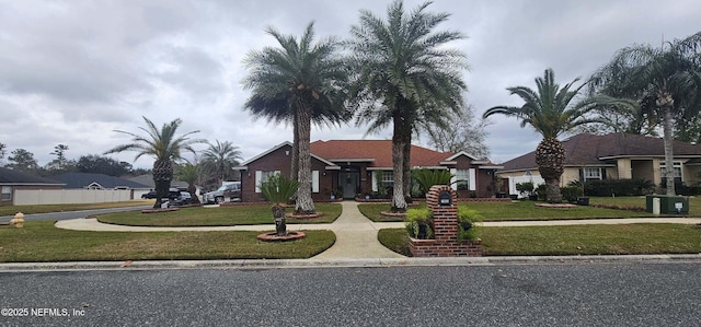 single story home featuring a front lawn and central air condition unit