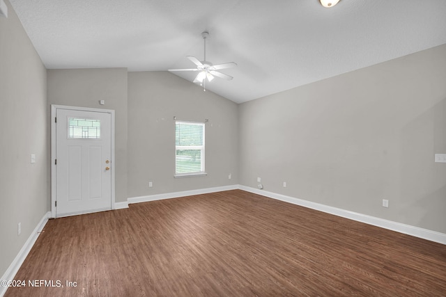 interior space featuring lofted ceiling, ceiling fan, baseboards, and wood finished floors